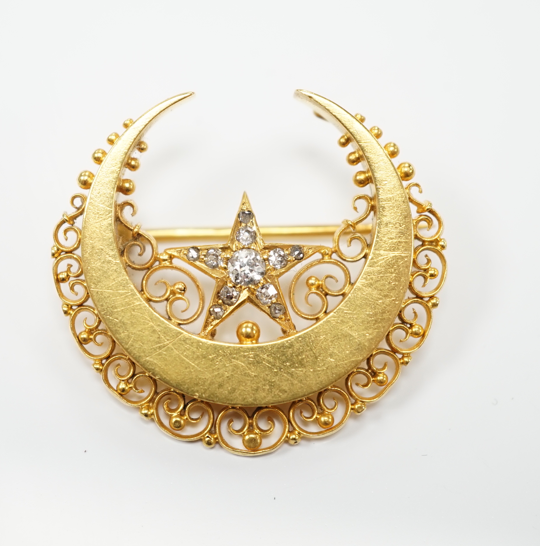 A late Victorian 15ct gold and diamond cluster set crescent and star brooch, 29mm, gross weight 6.8 grams.